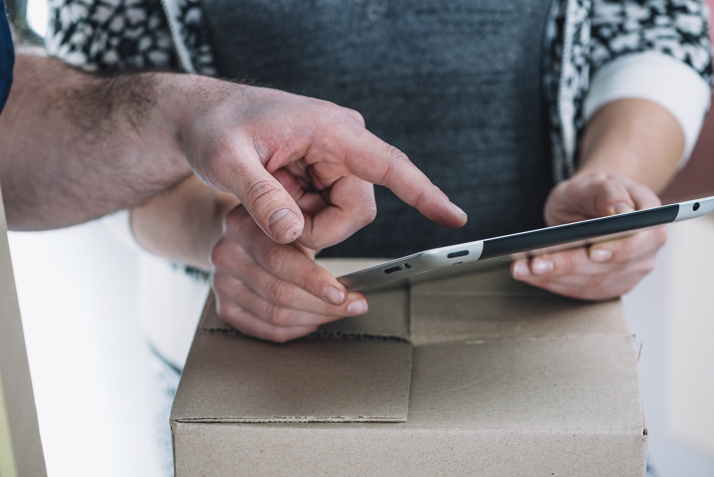 Reviewing express shipment details and paperwork on a parcel before pickup